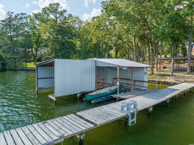 dock area with a water view and boat lift