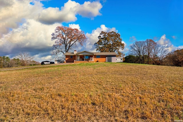 view of front of house featuring a chimney and a front yard