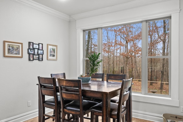 dining room featuring baseboards and ornamental molding
