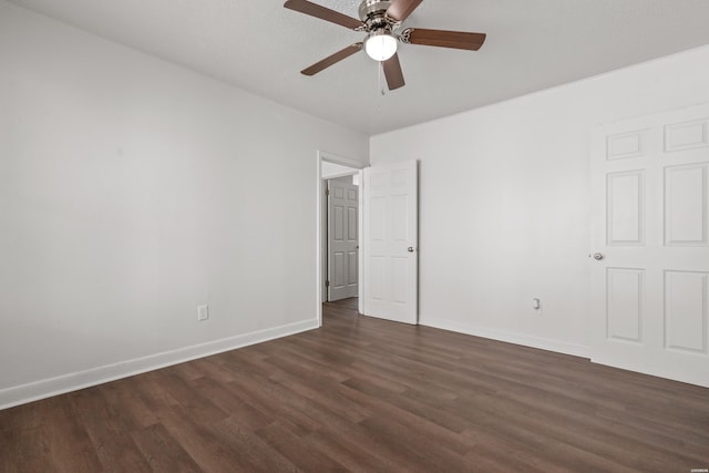 unfurnished bedroom featuring dark wood finished floors, ceiling fan, and baseboards