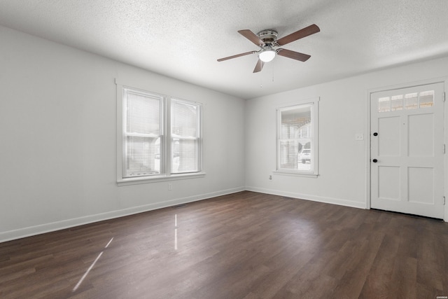 entryway with baseboards, dark wood-type flooring, and a textured ceiling