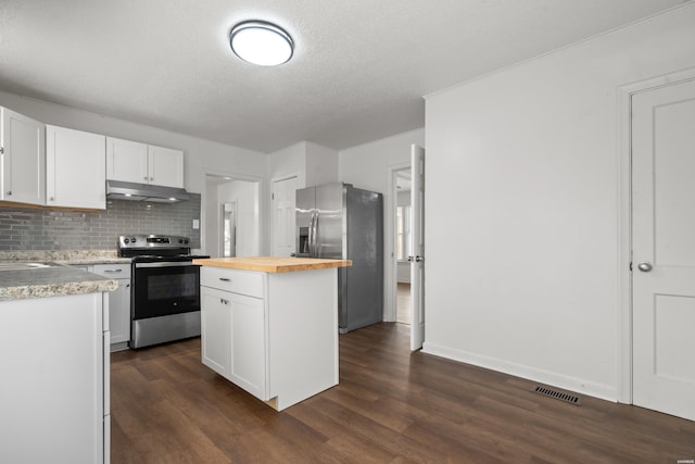 kitchen with visible vents, dark wood-style flooring, stainless steel appliances, under cabinet range hood, and wood counters