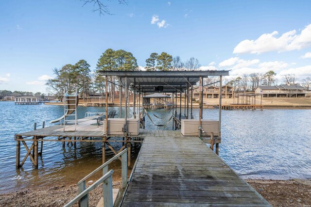 dock area with a water view and boat lift