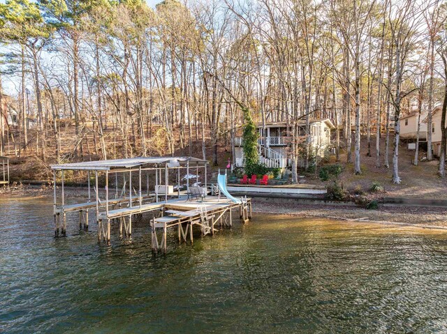 dock area with a water view and boat lift