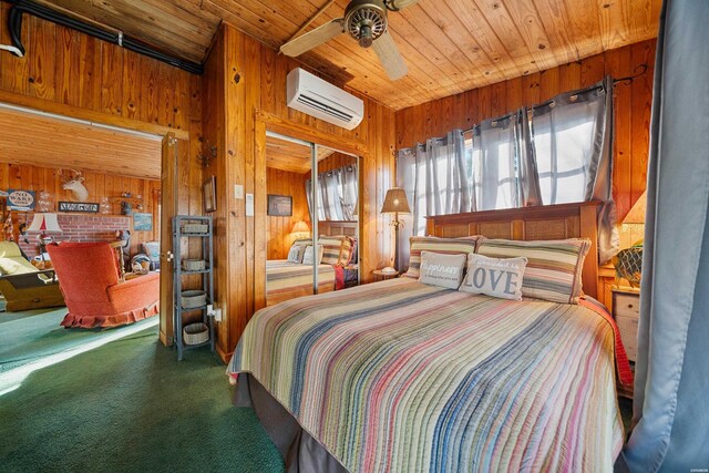 carpeted bedroom with a ceiling fan, wood ceiling, wood walls, and a wall mounted AC