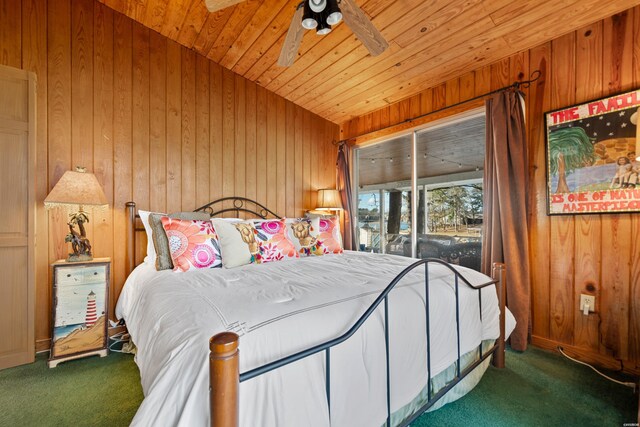 carpeted bedroom featuring lofted ceiling, wood ceiling, and wooden walls