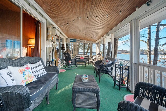 sunroom featuring vaulted ceiling, a water view, and wood ceiling