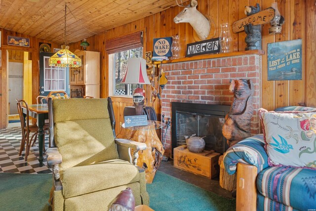 interior space with wooden walls, wooden ceiling, vaulted ceiling, carpet flooring, and a fireplace