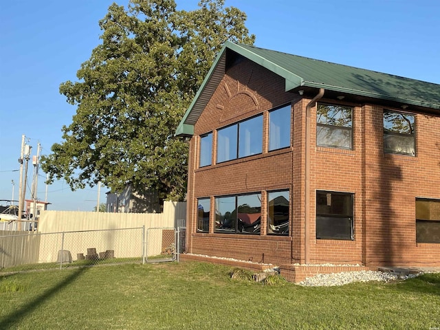 120 Butler Ln, Hot Springs, AR 71913 - rear view of property with brick siding, a lawn, and fence