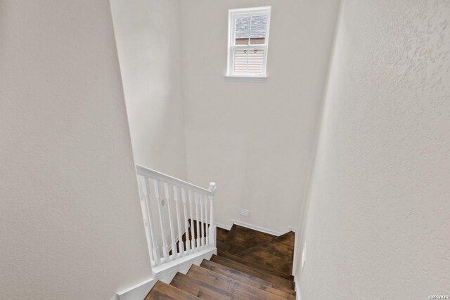 stairs with wood finished floors