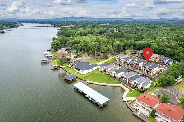 aerial view featuring a residential view, a water view, and a wooded view