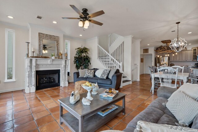 living room with crown molding, a fireplace, light tile patterned floors, recessed lighting, and stairs