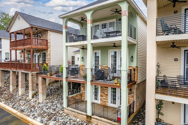 view of side of home featuring a balcony and ceiling fan