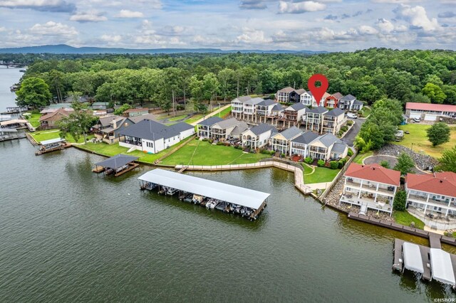 aerial view with a water view, a wooded view, and a residential view