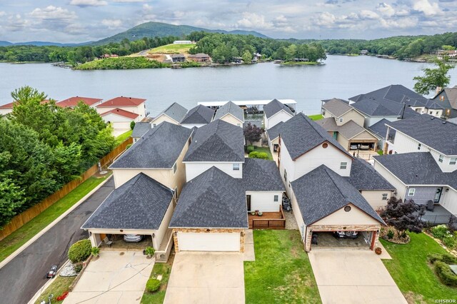 drone / aerial view featuring a water view and a residential view