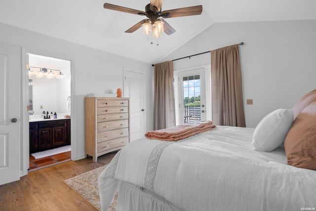 bedroom with ensuite bath, access to outside, vaulted ceiling, light wood-type flooring, and a sink