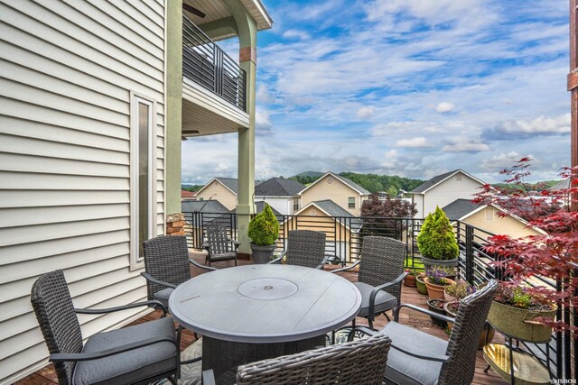 view of patio featuring a balcony and a residential view