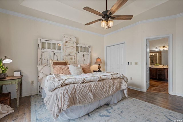 bedroom featuring ornamental molding, a closet, and wood finished floors