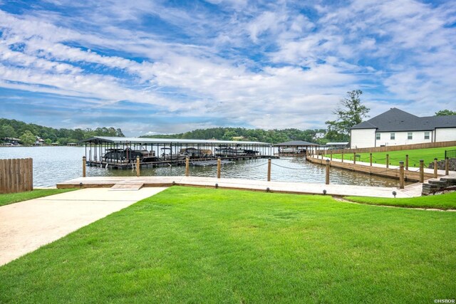 dock area with a water view and a yard