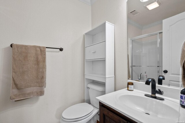 full bath featuring visible vents, toilet, ornamental molding, vanity, and a shower stall