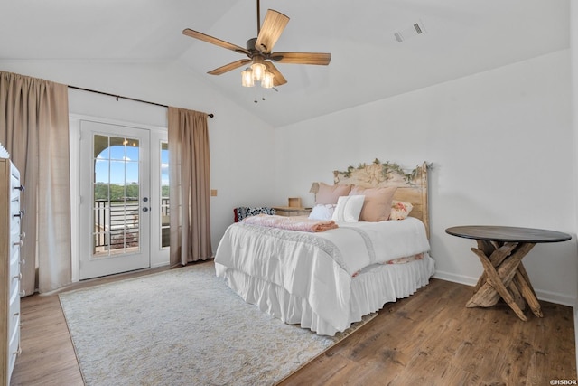 bedroom featuring visible vents, a ceiling fan, wood finished floors, access to outside, and vaulted ceiling