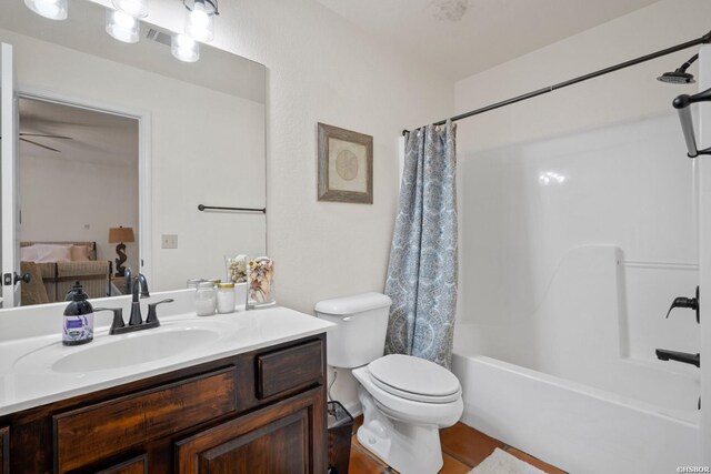 bathroom with toilet, shower / tub combo with curtain, and vanity