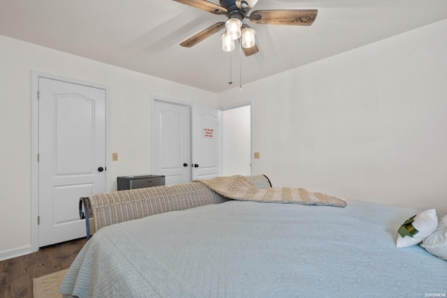 bedroom with dark wood-type flooring and ceiling fan