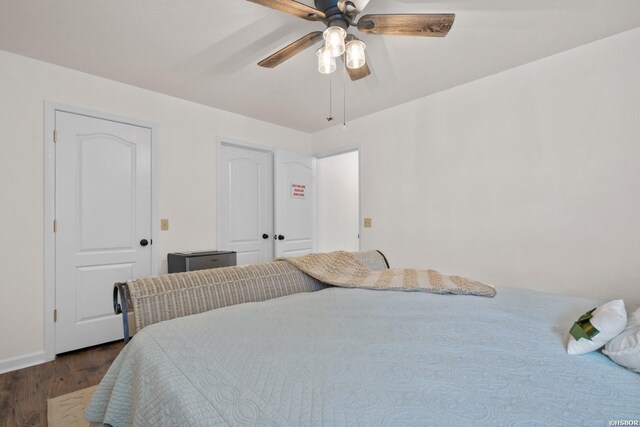 bedroom with dark wood-type flooring and ceiling fan