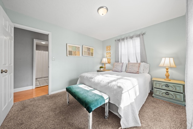 carpeted bedroom featuring baseboards