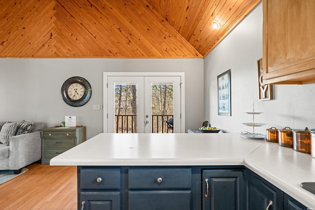 kitchen with a peninsula, light countertops, vaulted ceiling, wood ceiling, and french doors