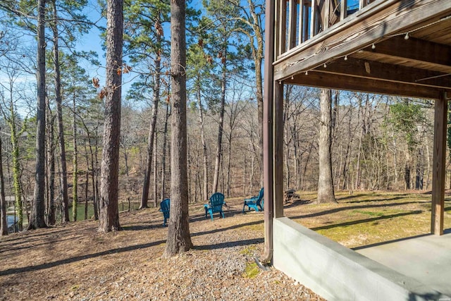 view of yard featuring a forest view