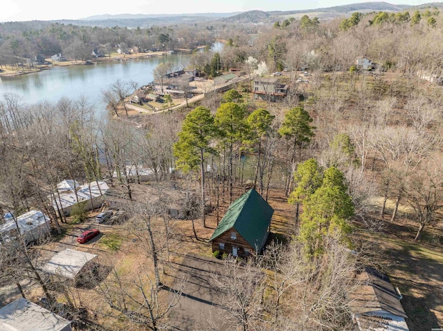 drone / aerial view with a forest view and a water view