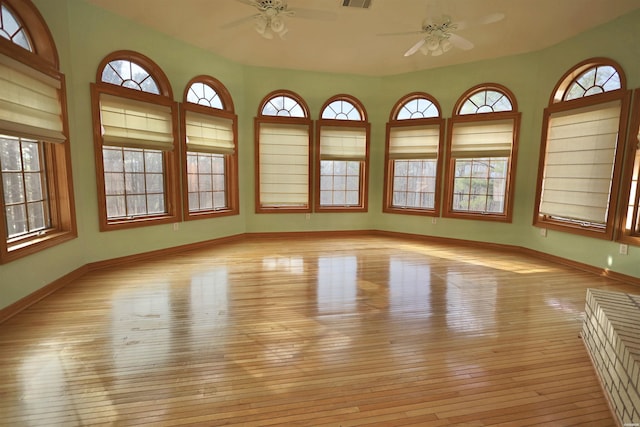 81 End Of Trail Rd, Mount Ida, AR 71957 - empty room featuring a ceiling fan, hardwood / wood-style floors, baseboards, and plenty of natural light