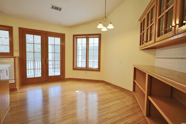 81 End Of Trail Rd, Mount Ida, AR 71957 - unfurnished dining area with light wood-style floors, a chandelier, vaulted ceiling, french doors, and baseboards