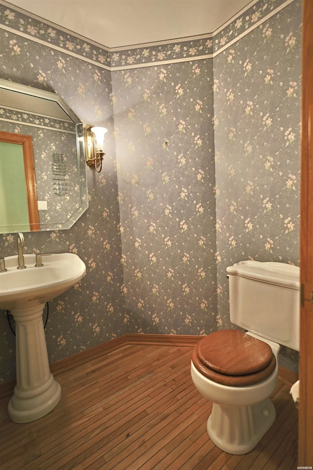 81 End Of Trail Rd, Mount Ida, AR 71957 - bathroom featuring wood-type flooring, wallpapered walls, toilet, and baseboards