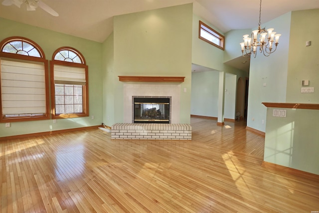 81 End Of Trail Rd, Mount Ida, AR 71957 - unfurnished living room featuring hardwood / wood-style floors, high vaulted ceiling, baseboards, a ceiling fan, and a glass covered fireplace