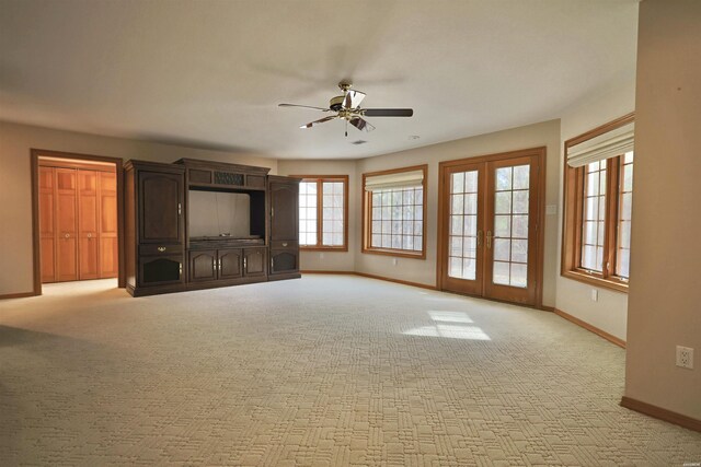 81 End Of Trail Rd, Mount Ida, AR 71957 - unfurnished living room with a ceiling fan, baseboards, light carpet, and french doors