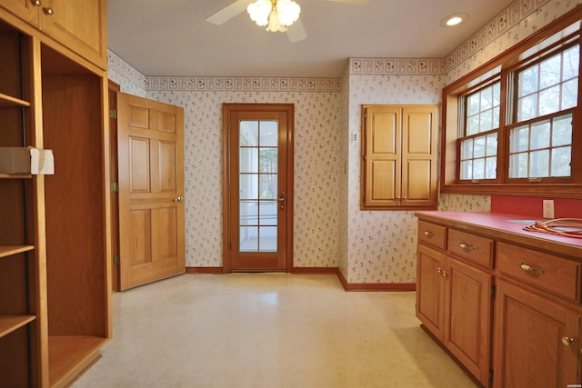 81 End Of Trail Rd, Mount Ida, AR 71957 - kitchen featuring wallpapered walls, ceiling fan, baseboards, and brown cabinets