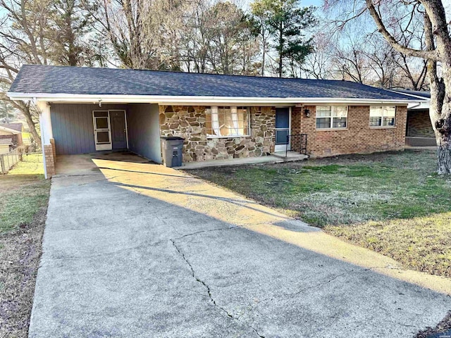 single story home featuring brick siding, concrete driveway, a carport, stone siding, and a front lawn