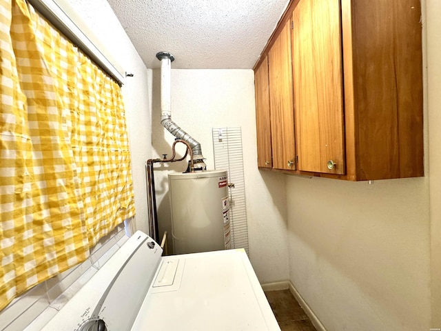 laundry area with a textured ceiling, gas water heater, baseboards, washer and dryer, and cabinet space