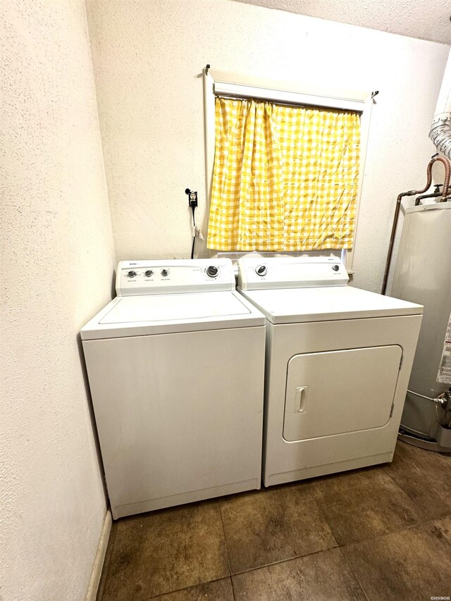 laundry area featuring laundry area, water heater, and washer and clothes dryer