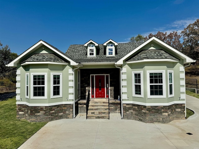 view of front of home with a shingled roof and stucco siding