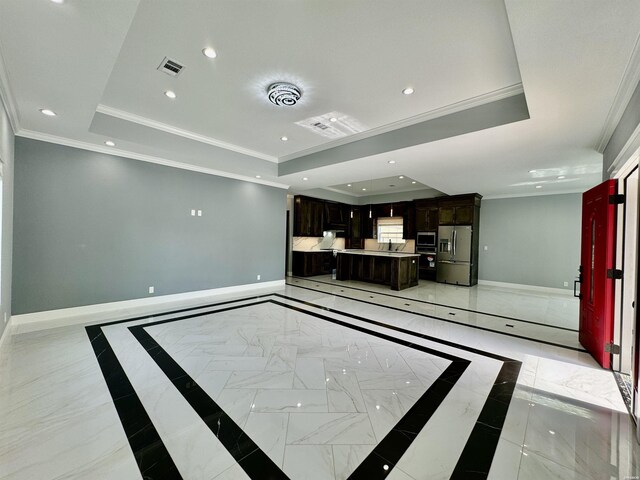 unfurnished living room featuring baseboards, a raised ceiling, and recessed lighting