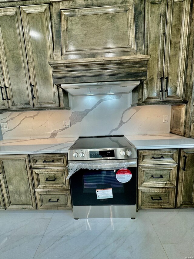 kitchen with marble finish floor, stainless steel electric stove, light countertops, premium range hood, and backsplash