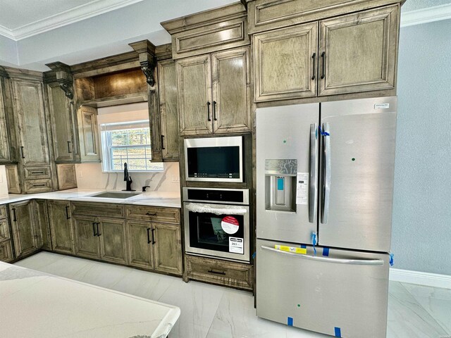 kitchen featuring a sink, marble finish floor, appliances with stainless steel finishes, and light countertops