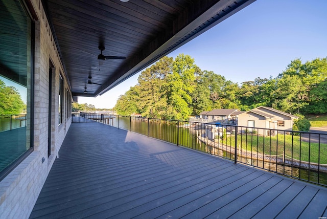 wooden terrace with a water view and a ceiling fan