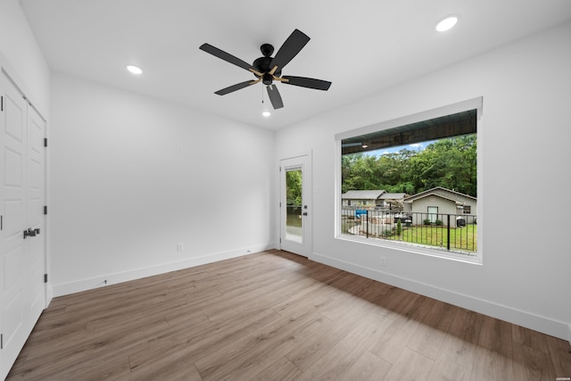 spare room with recessed lighting, ceiling fan, baseboards, and wood finished floors