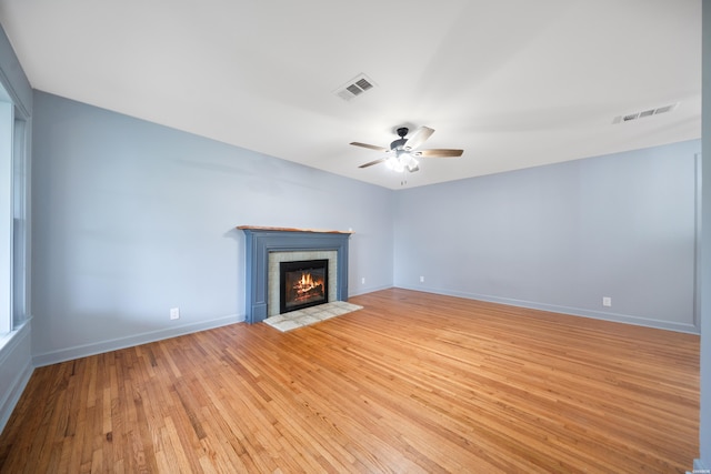 102 Burroughs St, Hot Springs, AR 71913 - unfurnished living room featuring ceiling fan, light wood-style flooring, and a brick fireplace