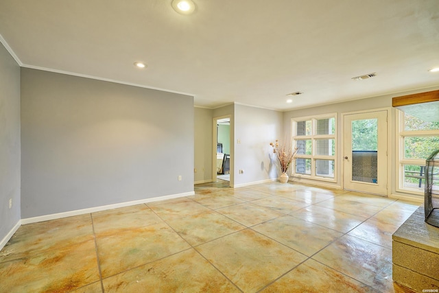 spare room with light tile patterned floors, visible vents, baseboards, and crown molding