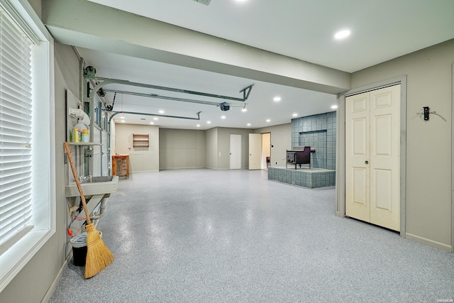 garage with recessed lighting and baseboards